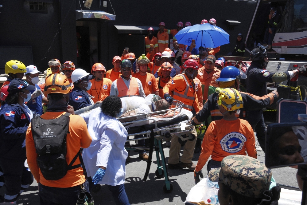 Rescue workers carry a person pulled from the wreckage of the Jet Set nightclub after its roof collapsed during a merengue concert in Santo Domingo, Dominican Republic, Tuesday, April 8, 2025. (AP)