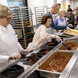 Volunteers prepare food at Community Servings, a Boston nonprofit that produces medically-tailored meals.