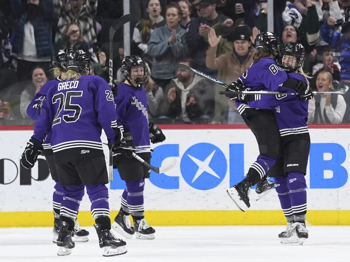 Minnesota forward Michela Cava, middle right, celebrates with defender Abby Cook, right, and teammates after scoring during the second period of a PWHL hockey game against Montreal on Wednesday night in St. Paul, Minn.