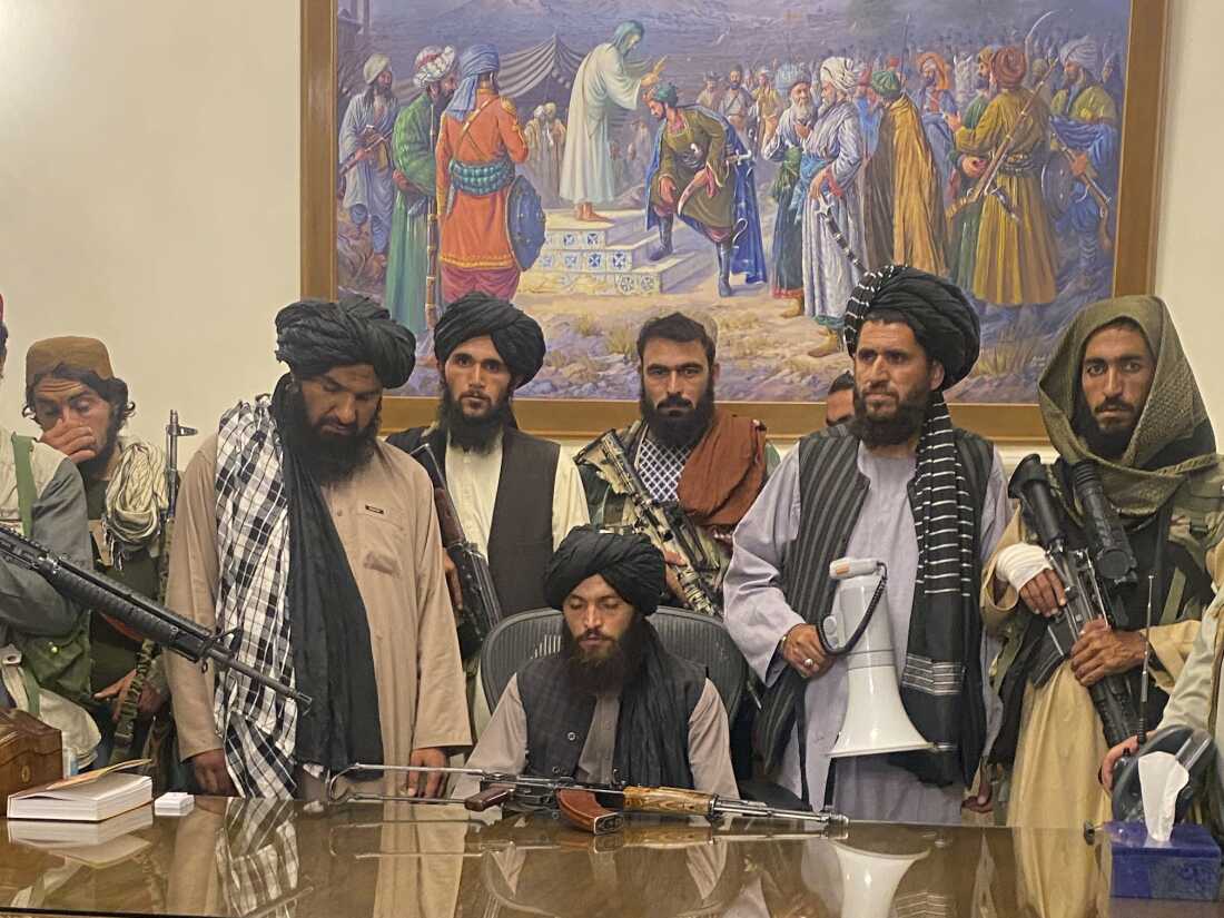 FILE - In this Aug. 15, 2021 file photo, Taliban fighters take control of Afghan presidential palace in Kabul, Afghanistan, after President Ashraf Ghani fled the country.