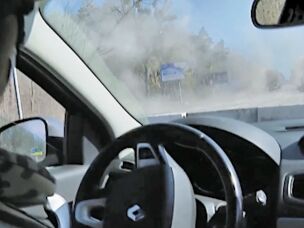 A view from inside the Fox News reporting team's car after a missile hit in front of it.
