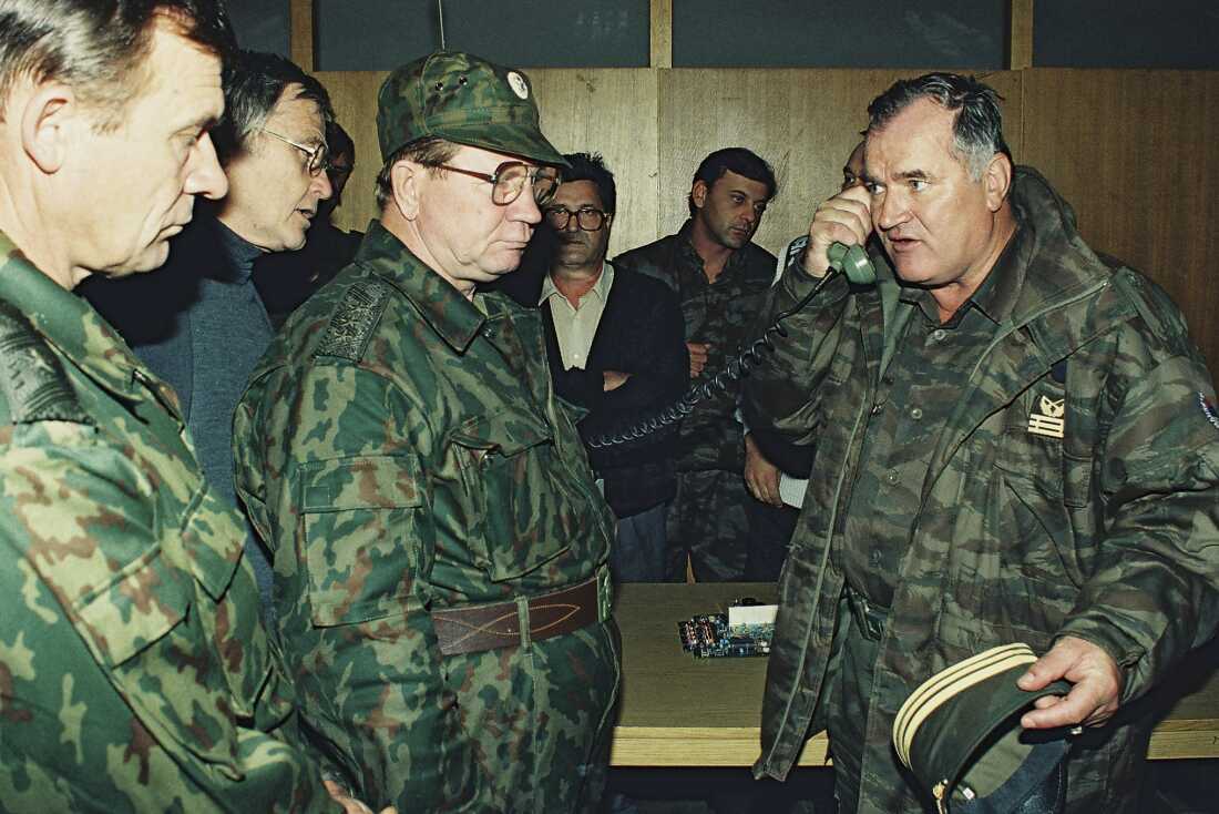 Bosnian Serb Gen. Ratko Mladic (right) talks on the phone next to Russian Army Gen. Vladimir Zurbenko (center) during the visit of a Russian Army delegation to the Bosnian town of Banja Luka in October 1995.