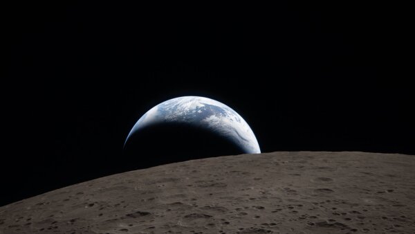 An image of the Earth captured from the Orion spacecraft window, with the surface of the moon in the foreground.