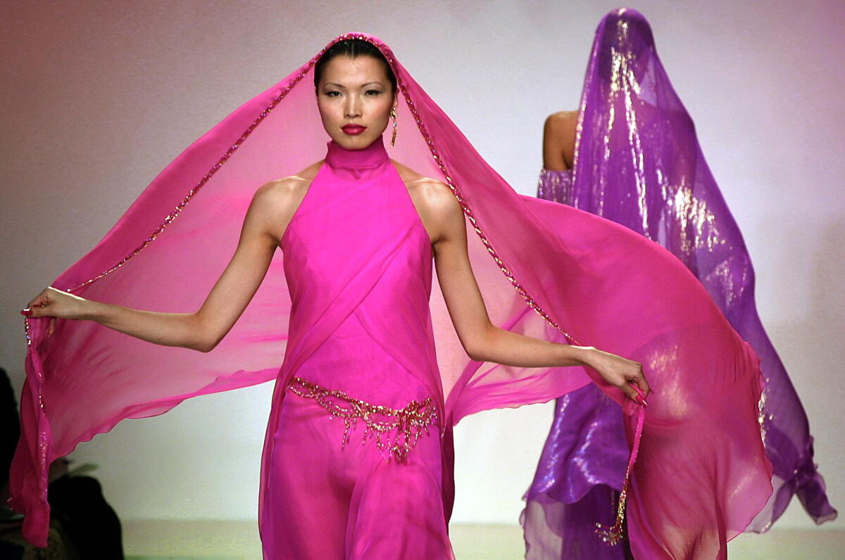 Bob Mackie, designer who dressed Marilyn Monroe, Elton John and Cher, dies at 87 2 An example of Bob Mackie's work in haute couture: A model presents a hot pink chiffon gown with jeweled hip belt at Mackie's show during Fall 2001 Fashion Week in New York.