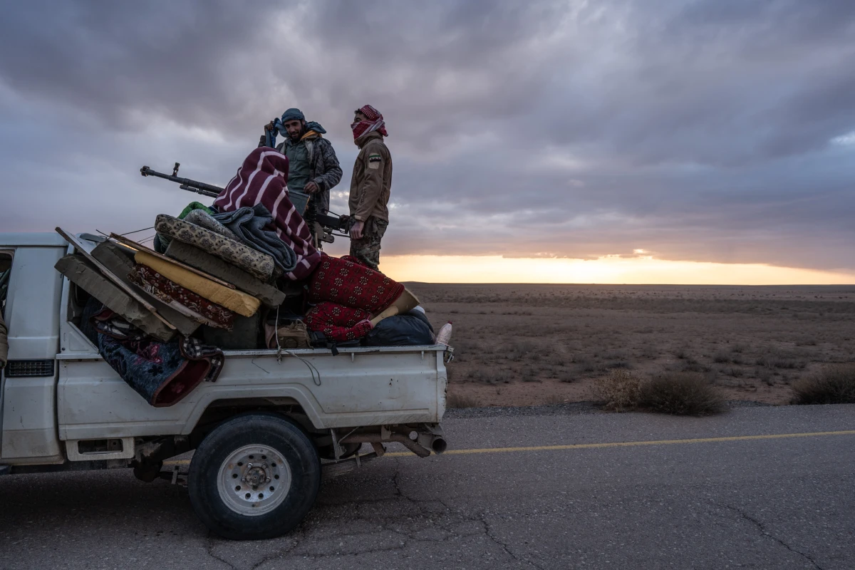 Free Syrian Army members escort the convoy taking Timmerman to be handed over to U.S. forces on Friday.