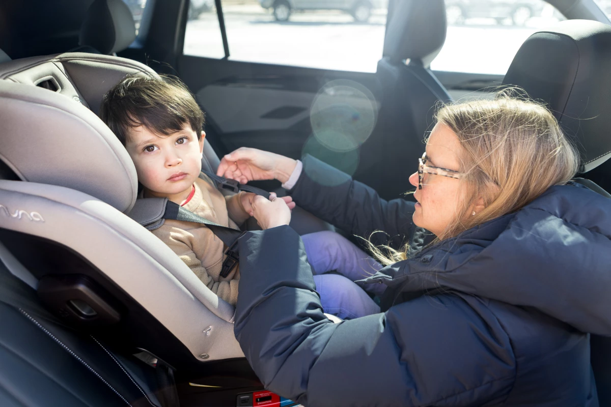 Elizabeth Kanagawa, a certified child passenger safety technician, demonstrates how to adjust the harness of a car seat. She is also the owner of Three Littles, a children's store that sells car seats and strollers, among other items, in Washington, D.C.