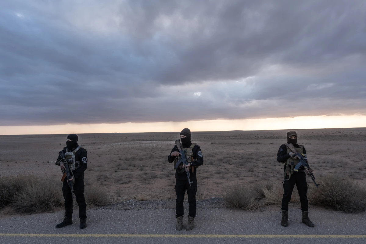 Syrian forces with Hayat Tahrir al-Sham, which led the overthrow of Bashar al-Assad's regime, secure the area where Timmerman is transferred to U.S. forces near the Syrian border with Iraq and Jordan.