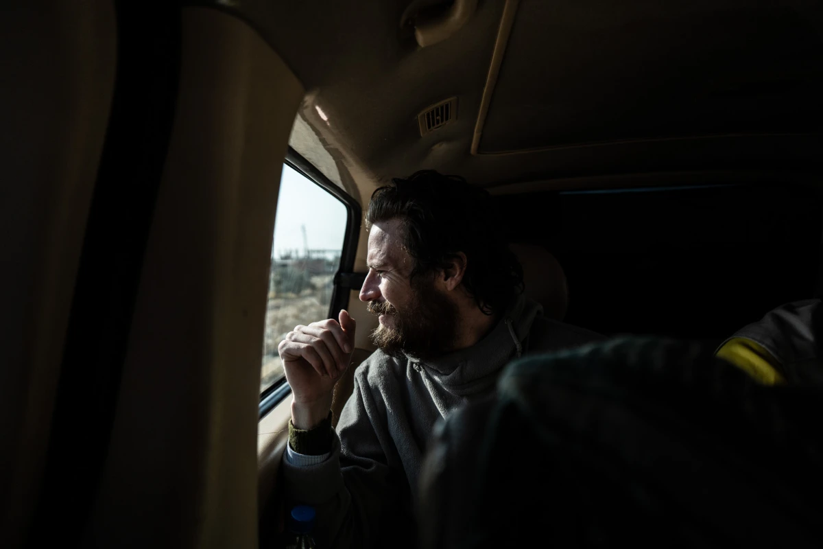 Travis Timmerman looks out the window of a van as he is taken to be handed over to U.S. forces near the Syrian border with Iraq and Jordan on Dec. 13.