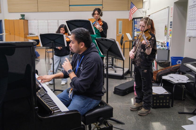 Serjoe Gutierrez sits at a piano to work with his students in the spring of 2025. He is the first teacher KIBSD hired as part of its H-1B visa program in 2022.