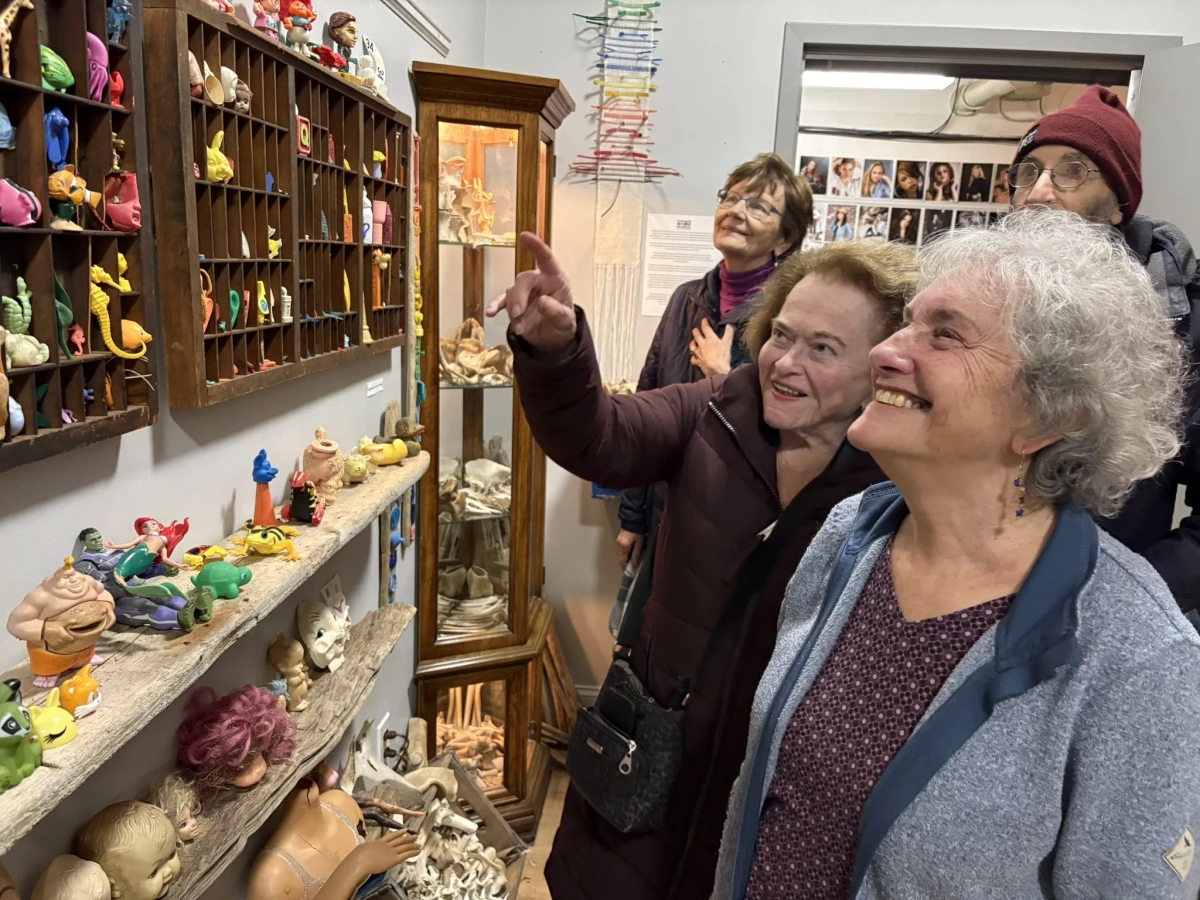 Elayne Byrne (pointing) and Sharon Wintner (right) were among the visitors recently exploring the Plum Island Museum of Lost Toys & Curiosities.