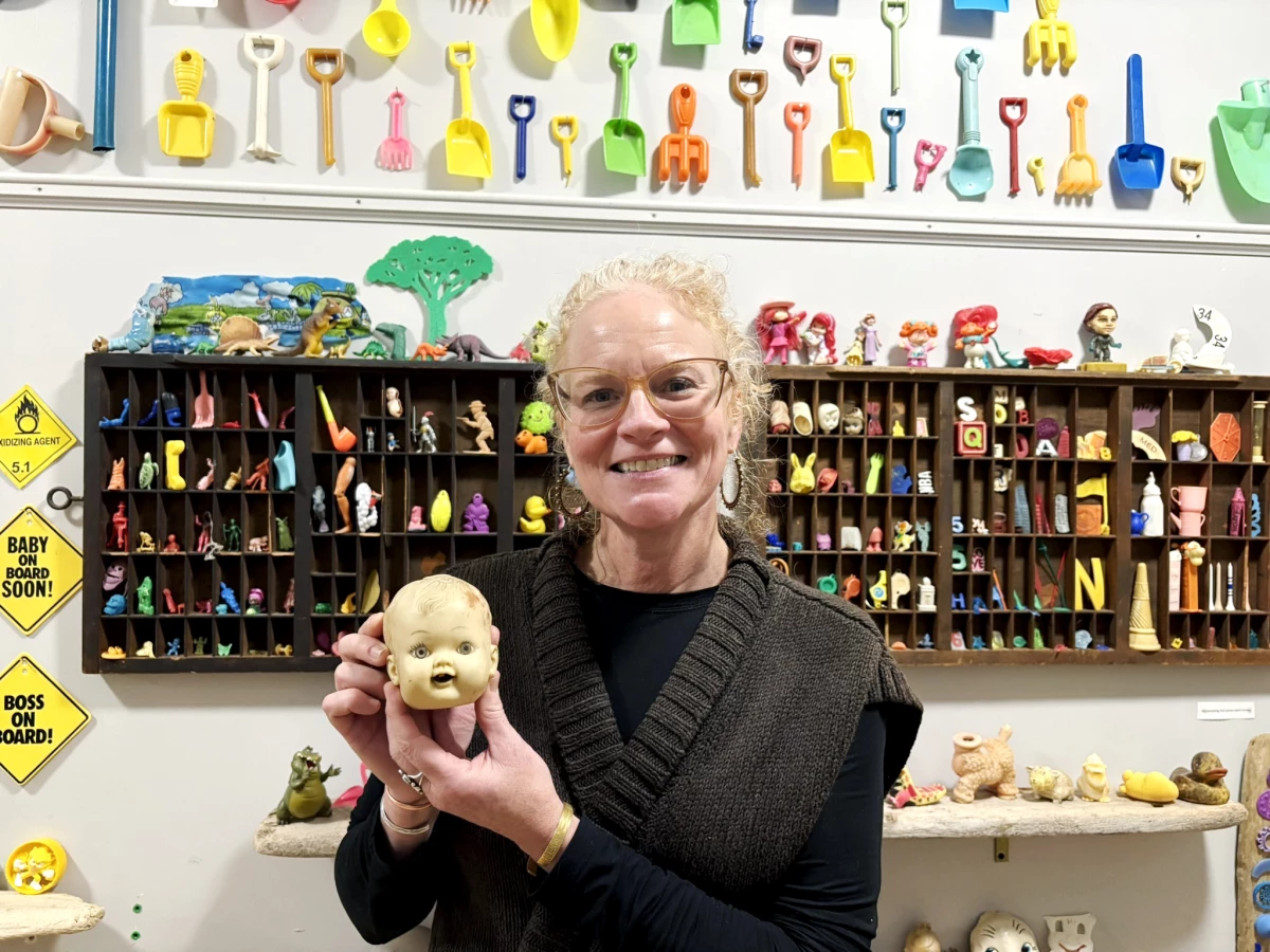 Corinn Flaherty holds the first doll head she found washed ashore in 2015. It propelled her 'descent down the flotsam rabbit hole' and was her inspiration for the Plum Island Museum of Lost Toys & Curiosities.