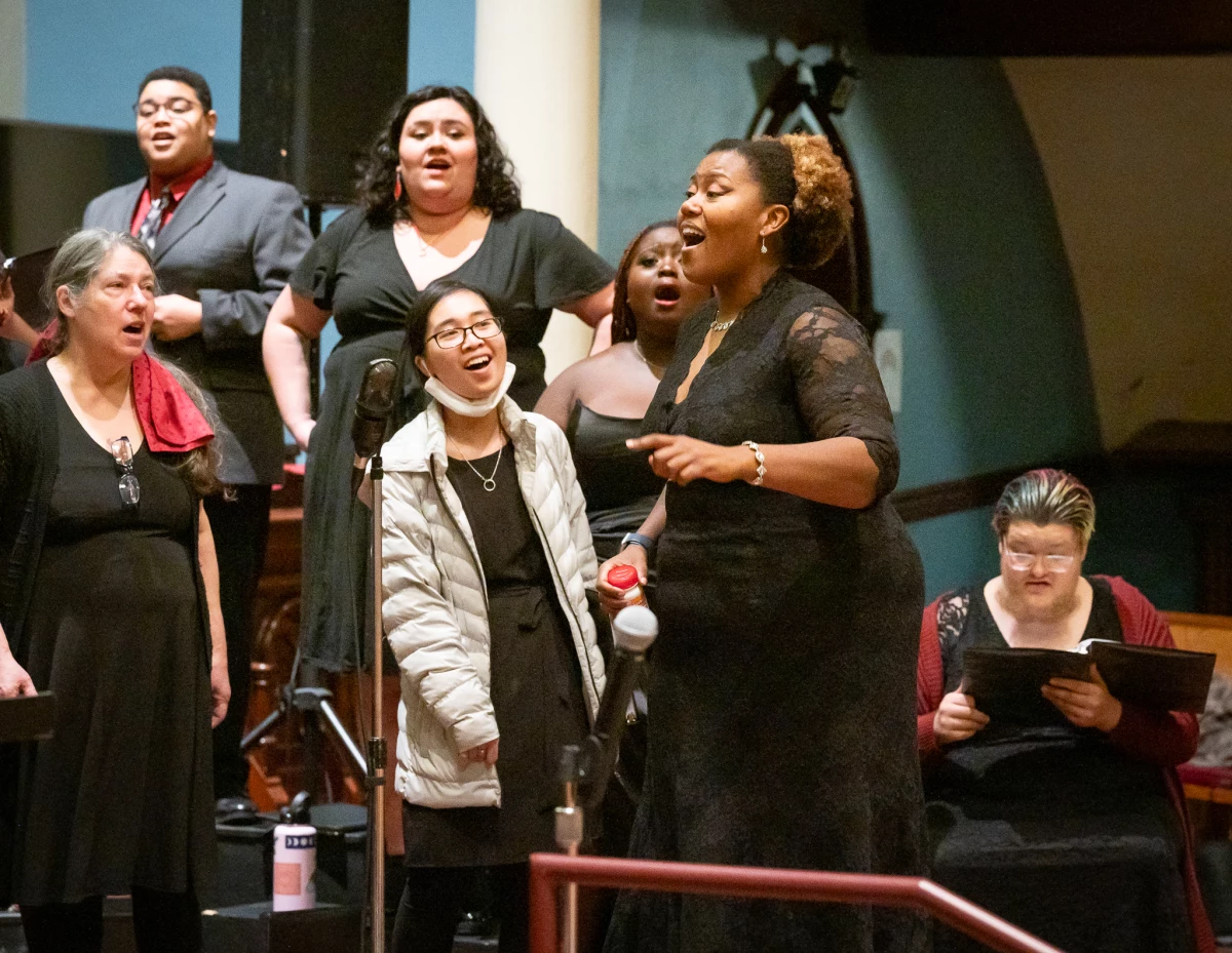 Coty Raven Morris conducts the combined Rose and Thorn Choirs singing an African piece called 'Modimo' at the From the Dust concert performed at First Congregational Church in Portland in November, 2023.