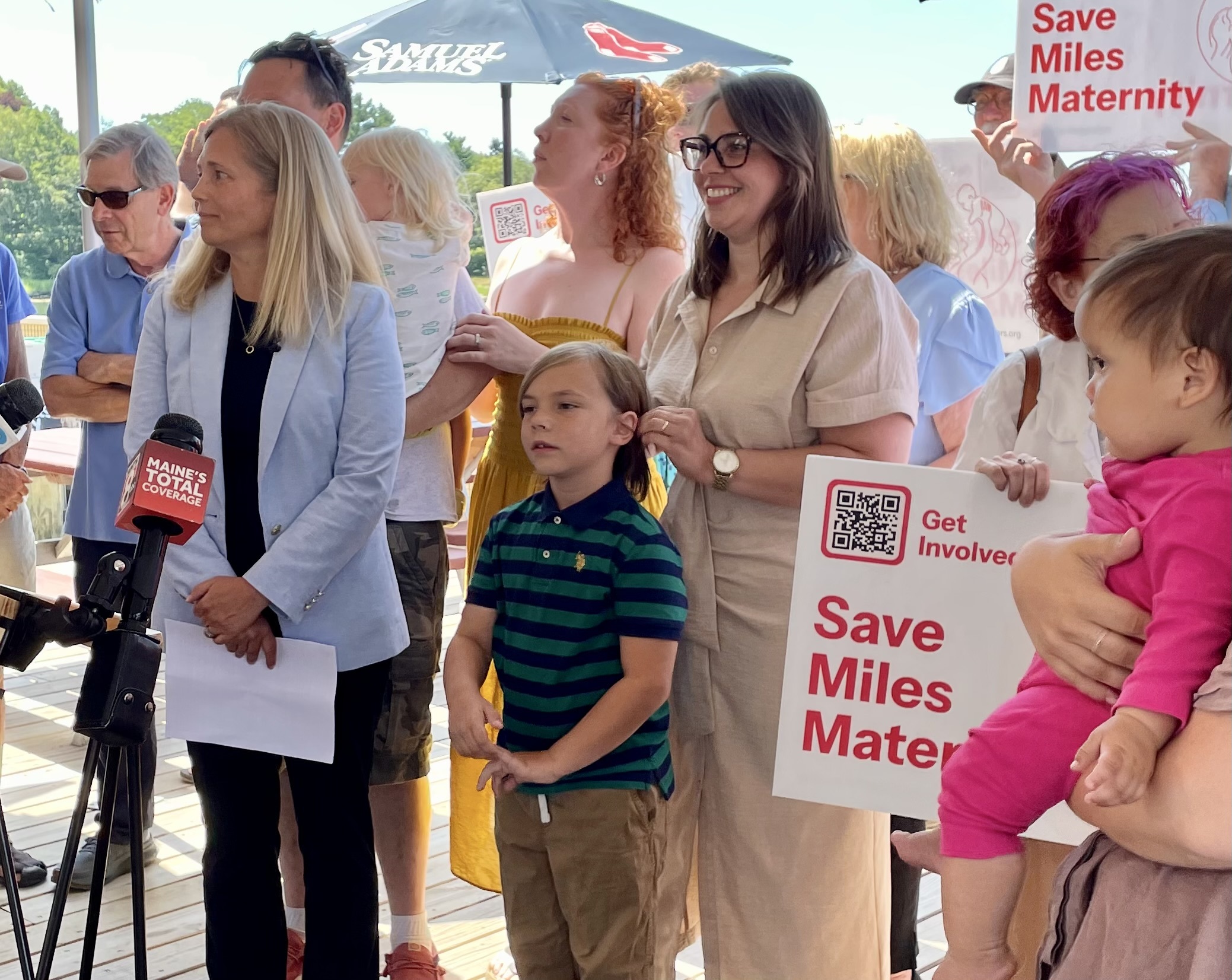 Miles Delivers Action Coalition cofounder Margaret Reynolds, center, stands with her son Otto at a joint press conference July 24 with Maine Democratic gubernatorial candidate Hannah Pingree (left).