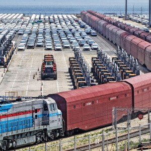 Heavy equipment and cars are prepared for shipment by rail in Yantai, eastern China's Shandong province, on June 20, 2026.