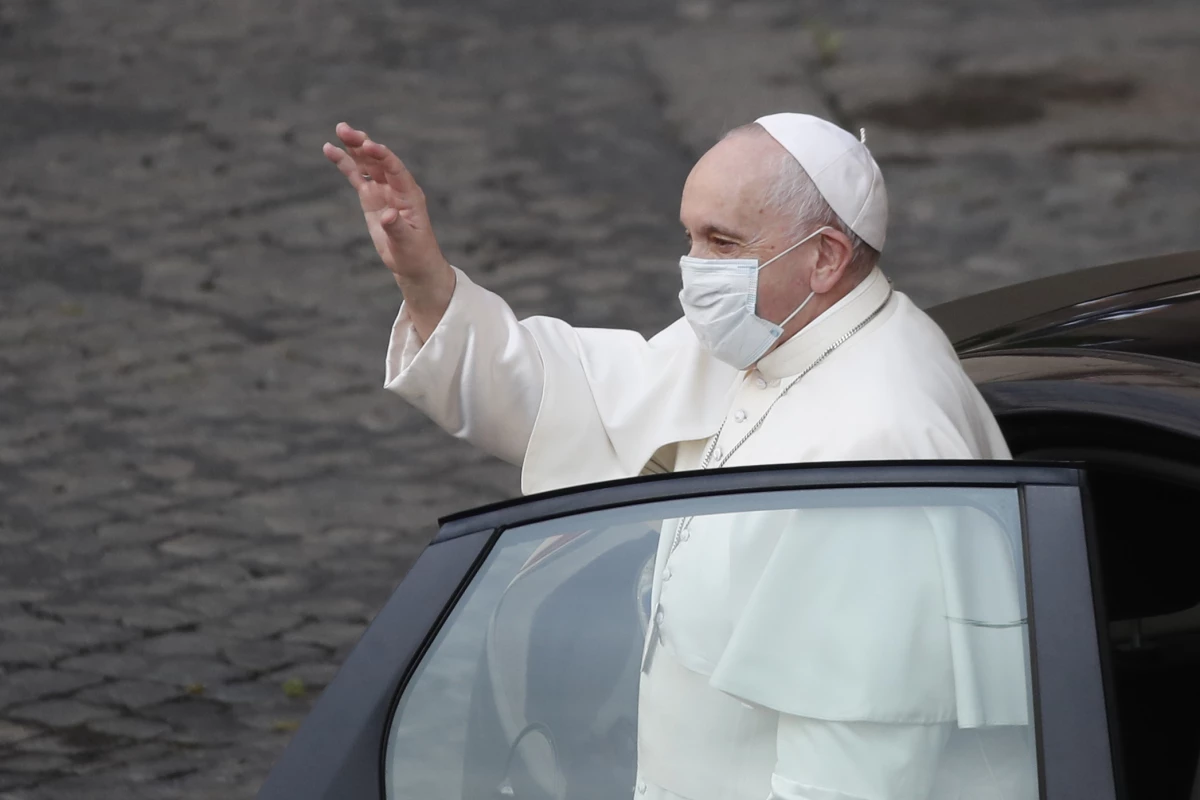Pope Francis wears a face mask to curb the spread of COVID-19 as he arrives in the Vatican's San Damaso Courtyard for his weekly general audience on May 12, 2021.