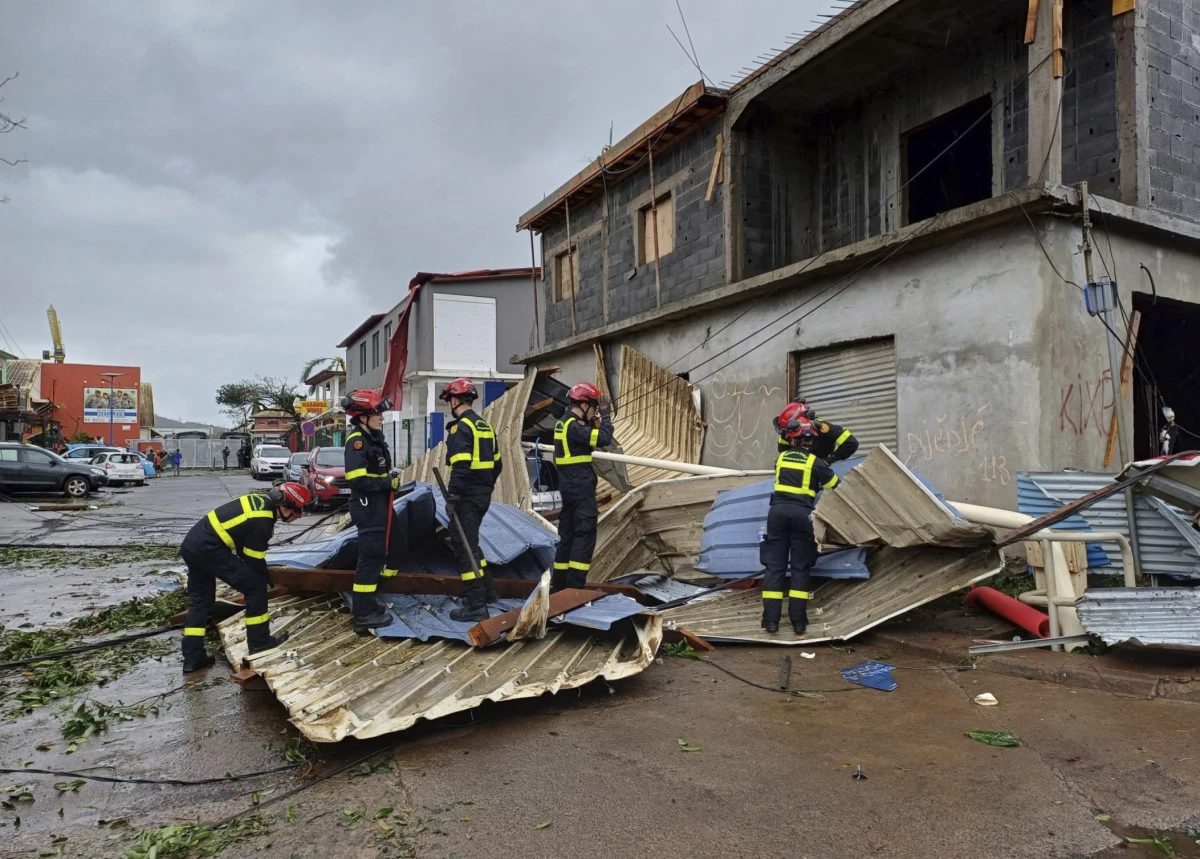 This photo provided Dec.15, 2024 by the Civil Security shows rescue workers clearing an area in the French territory of Mayotte in the Indian Ocean, after Cyclone Chido caused extensive damage with reports of several fatalities.