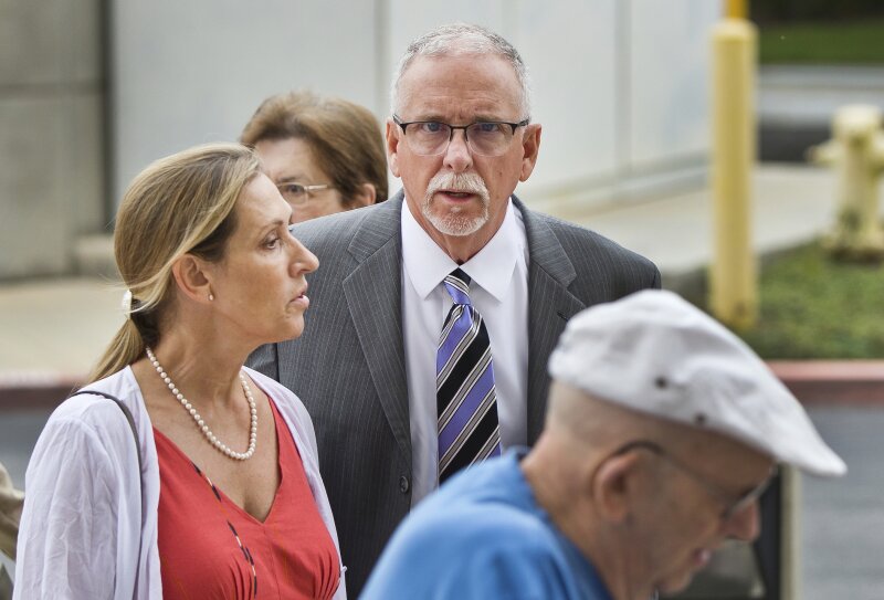 FILE - In this June 26, 2019 file photo UCLA gynecologist James Heaps, center, and his wife, Deborah Heaps, arrive at Los Angeles Superior Court.