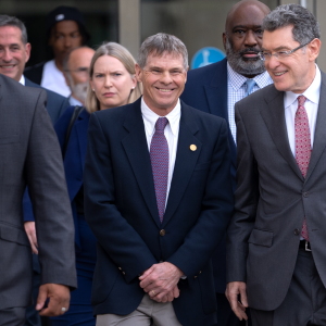 Former Olympic canoeist David Hearn, left, and his attorney Norm Eisen, right, leave D.C. court with a smile in early September after a hearing about the dismissal of his vandalism charges.