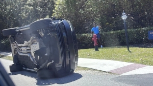 Golfer Tiger Woods stands by his overturned vehicle in Jupiter Island, Fla., on Friday, March 27, 2026.