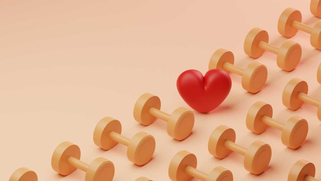 Conceptual image of a grid pattern of yellow dumbbells covering half the screen with a single red heart in between, could illustrate ideas around heart health and exercise or love for working out