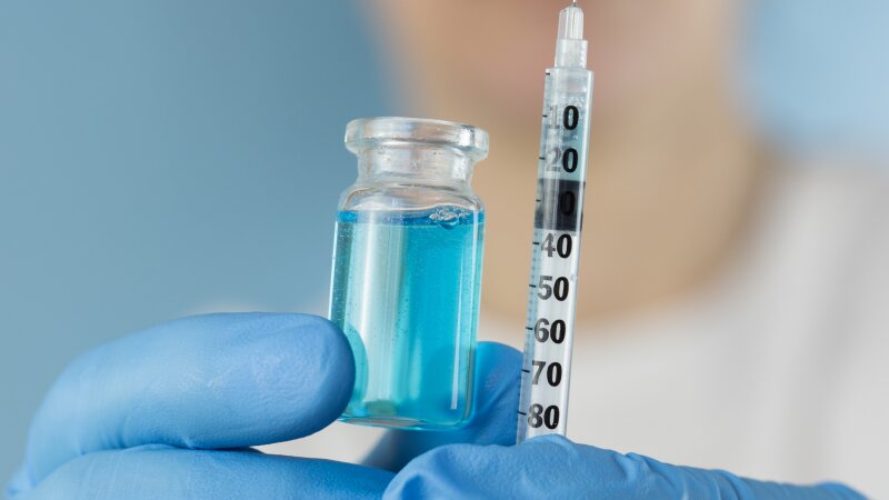 Image 28: ghk cu peptide vial syringe medical hands holding liquid blue solution medication vaccine close up view looking away concept of biochemistry, healthcare, pharmacology.