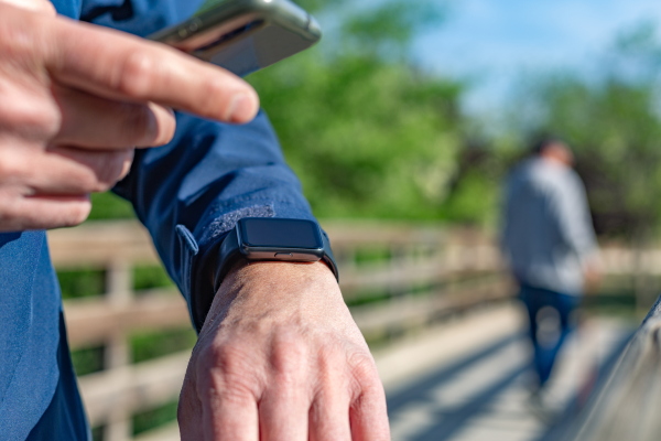Mature man using technology for his daily routines. For example, counting the steps he takes each day.