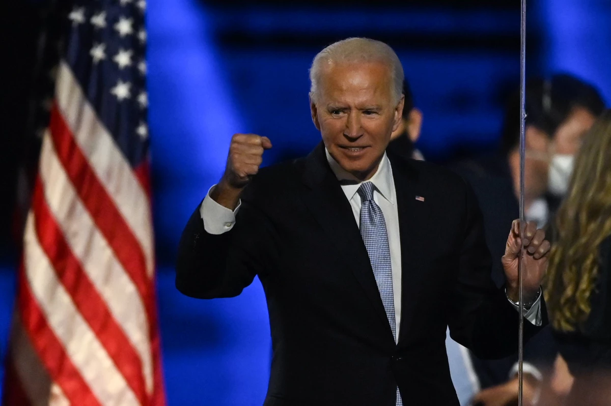 President Biden holds up his fist after delivering remarks in 2020 in Wilmington, Del., after being declared the winners of the presidential election.