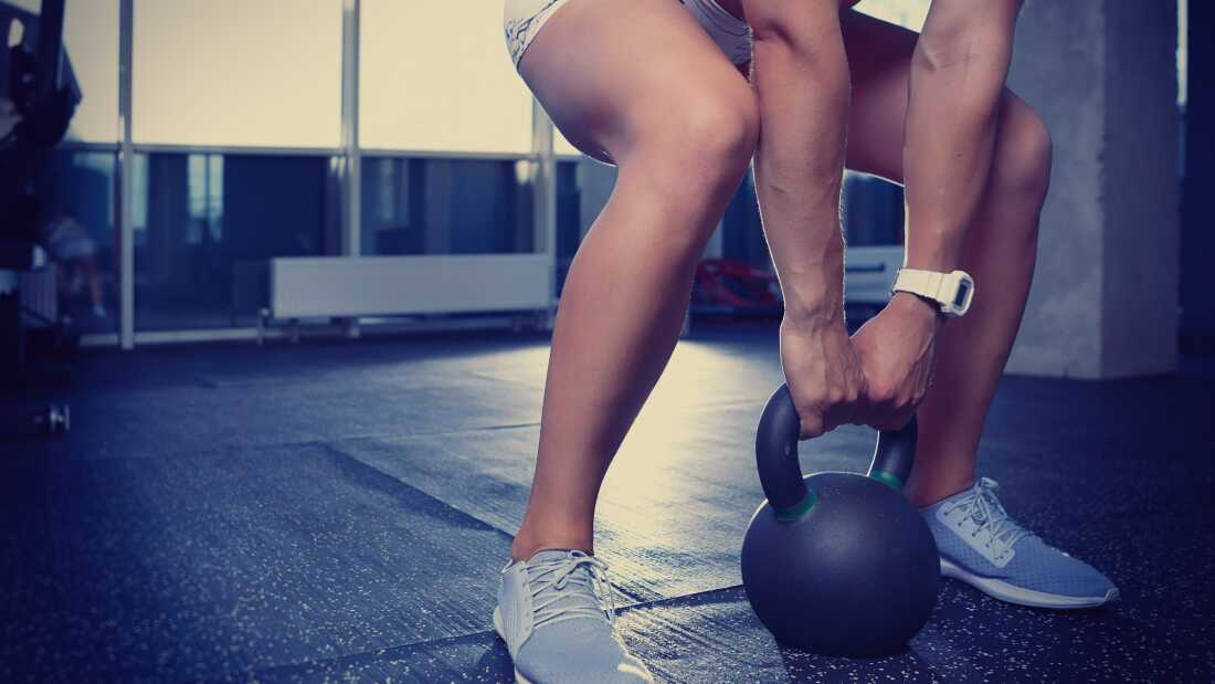 Athletic young woman doing exercises in gym
