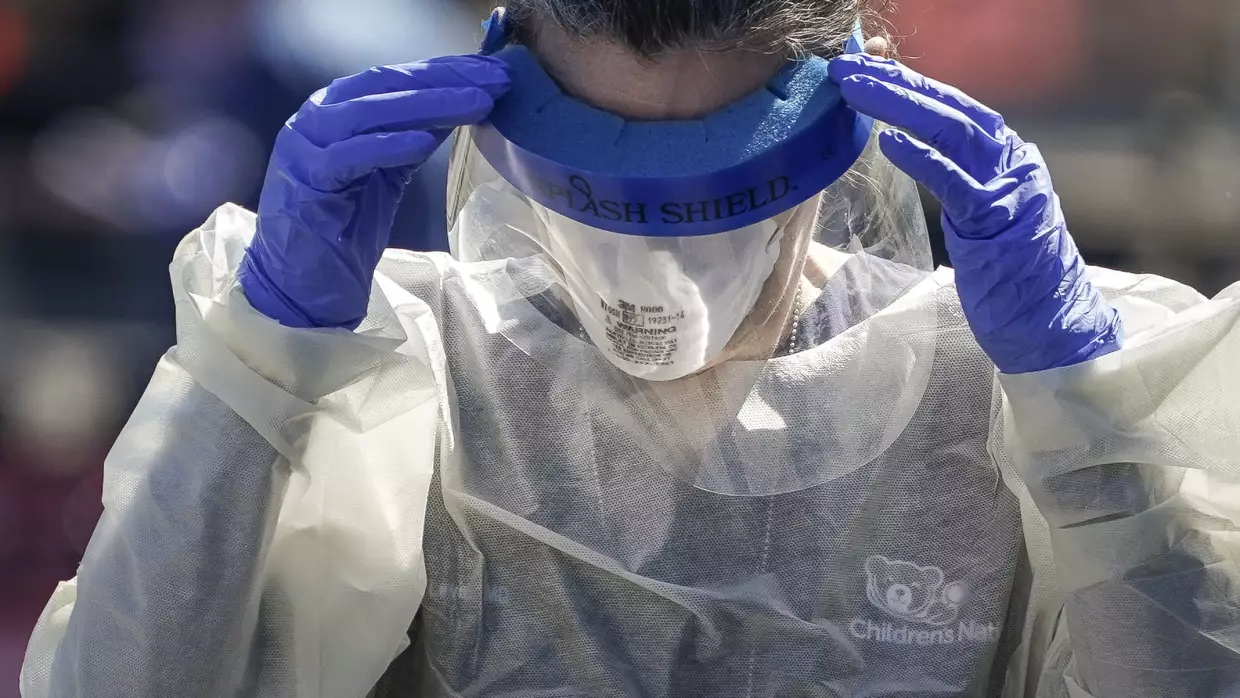 A medical professional from Children's National Hospital works at a coronavirus drive-through testing site on April 2, 2020, in Washington, D.C. The COVID-19 pandemic is shaping how many Americans are reacting to Ebola and hantavirus.