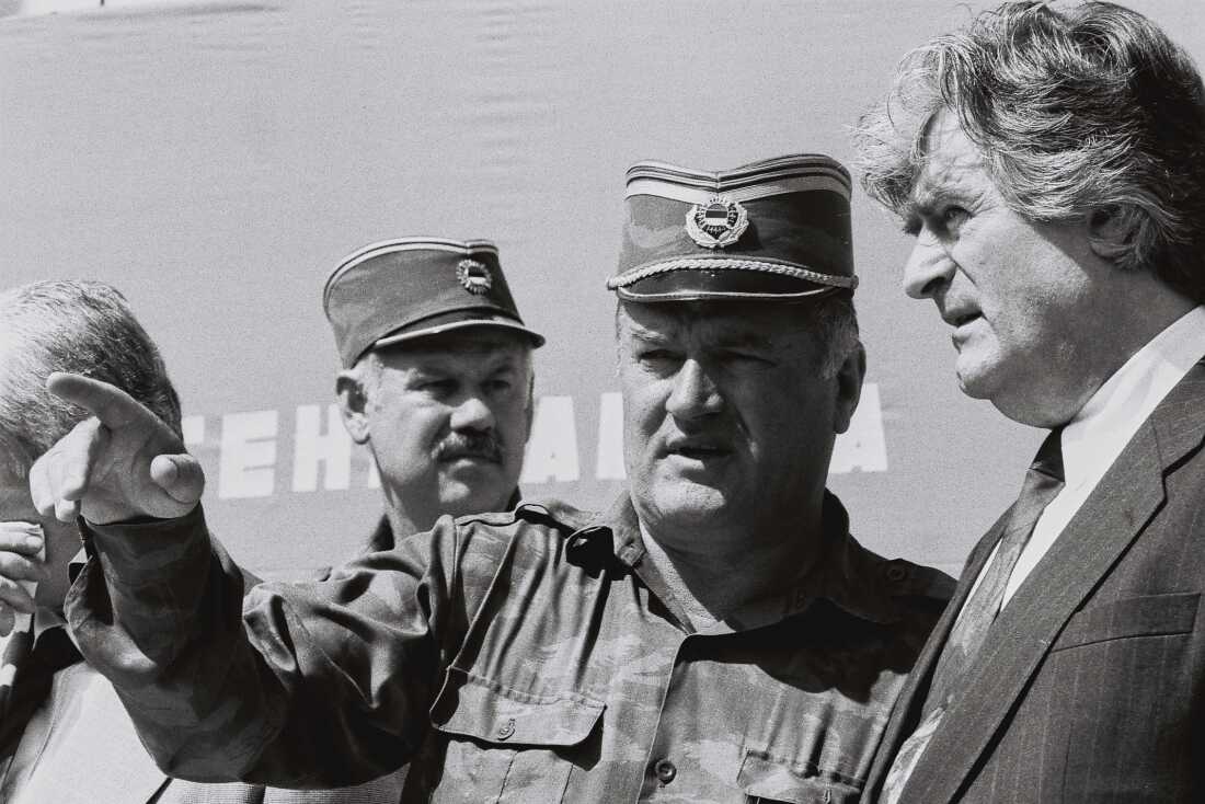 Bosnian Serb General Ratko Mladic (center) speaks with Bosnian Serb President Radovan Karadzic (right) in the Bosnian town of Banja Luka, in 1994.
