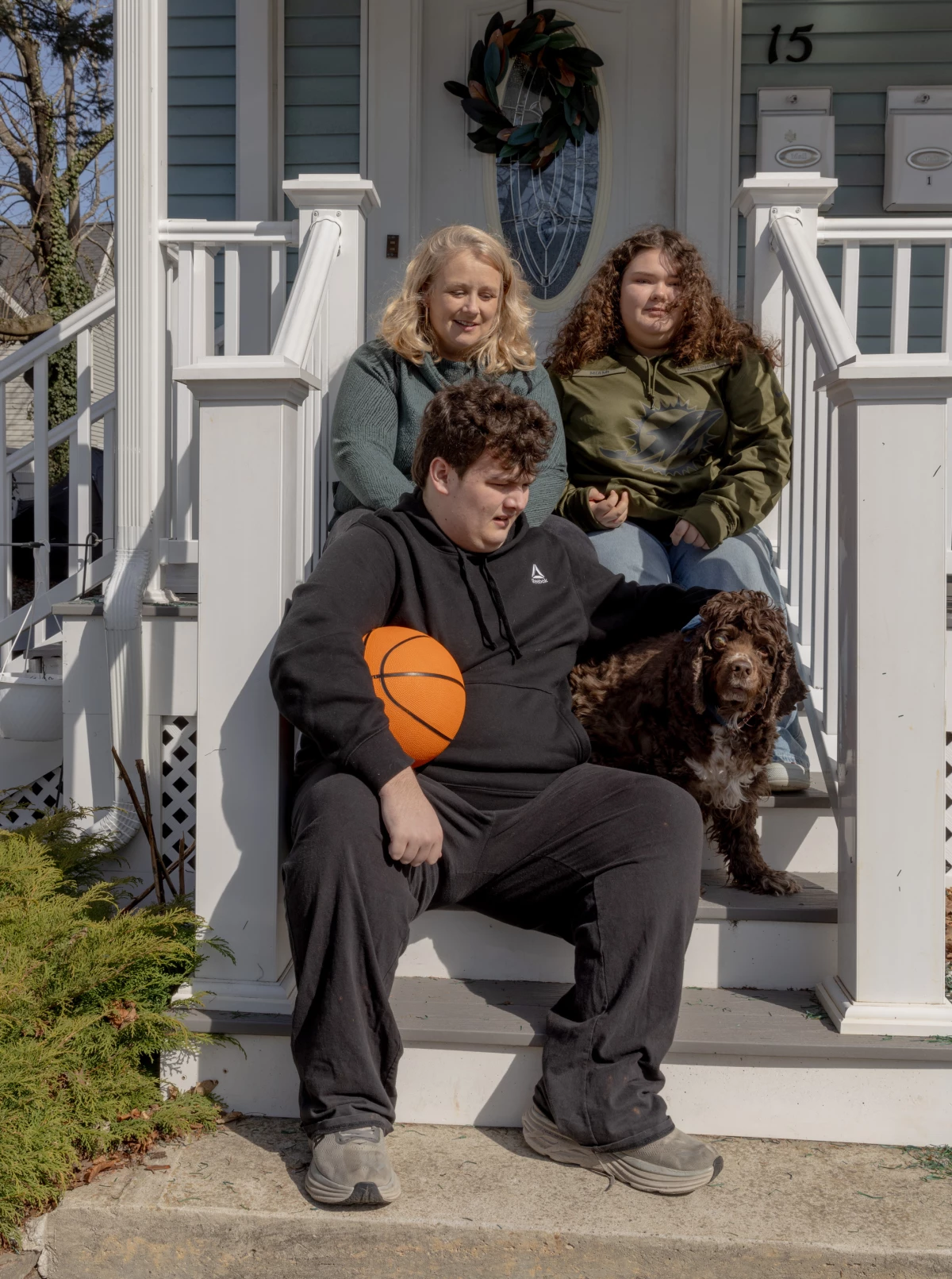 Jessie Damroth poses for a family photo with her daughter Ayden, her son Logan and Logan's dog, Miller. The family adopted Miller to help Logan, and Damroth often calls the cocker spaniel her 'chubby cherub.'