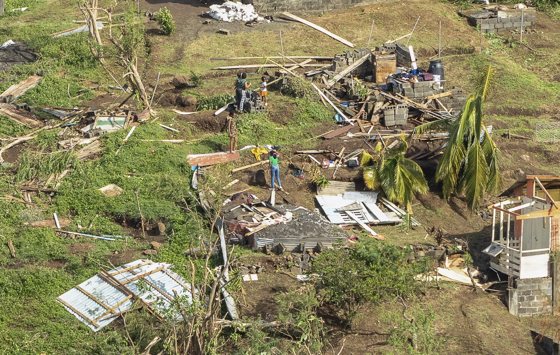 Family members survey their home destroyed by Hurricane Beryl, in Ottley Hall, St. Vincent and the Grenadines, on Tuesday. Beryl is the most powerful storm to form this early in the Atlantic hurricane season. (AP)