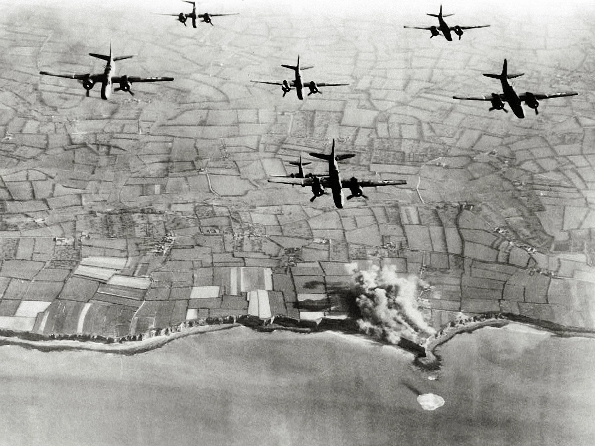 A-20 bombers fly over German positions at the Pointe Du Hoc coastal battery on May 22, 1944, weeks before D-Day.