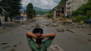 A boy looks at the devastation caused by flash flooding along the Trishuli River in Nepal's Nuwakot district on Wednesday.