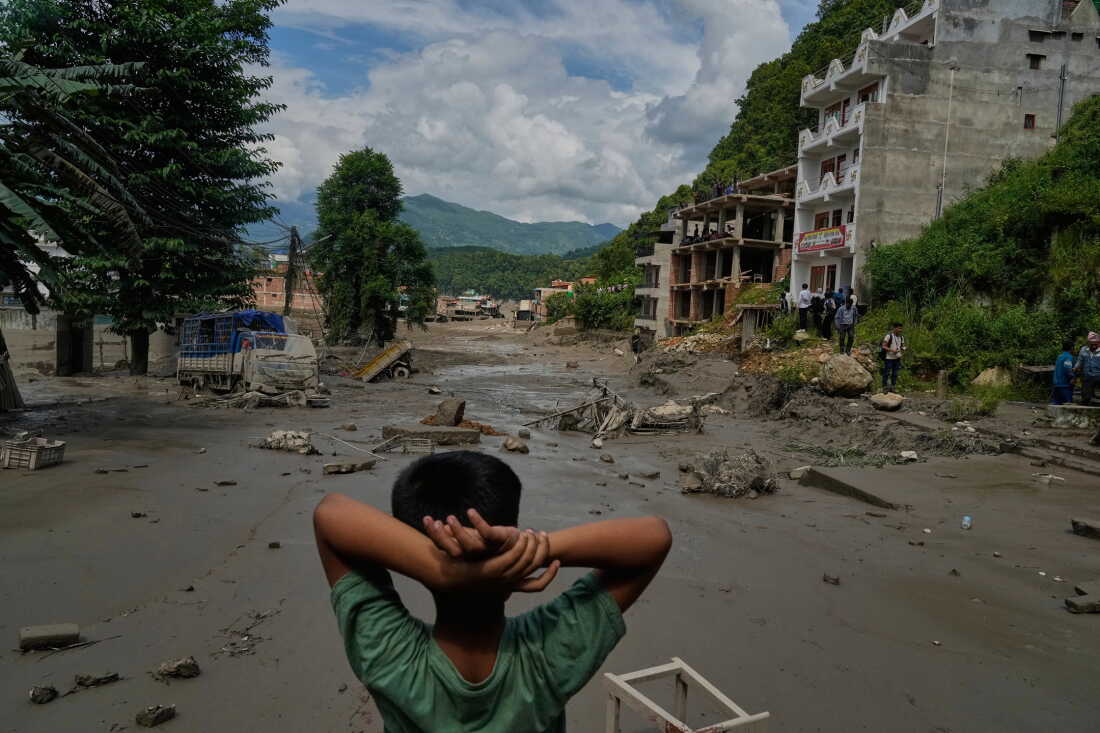 A boy looks at the devastation caused by flash flooding along the Trishuli River in Nepal's Nuwakot district on Wednesday.