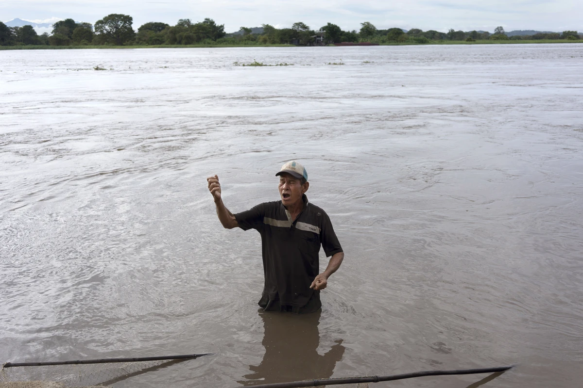 José Benito Africano Mendoza sings cumbias to people hanging out along the Magdalena River in El Banco, Magdalena, Colombia, on Aug. 7, 2022.