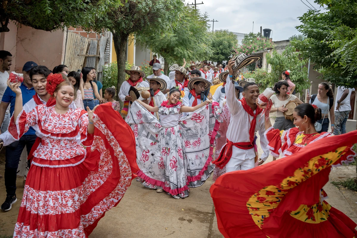 Gaitero groups, dancers and the general public parade to the cemetery in San Jacinto, Colombia, on Aug. 14, 2022.