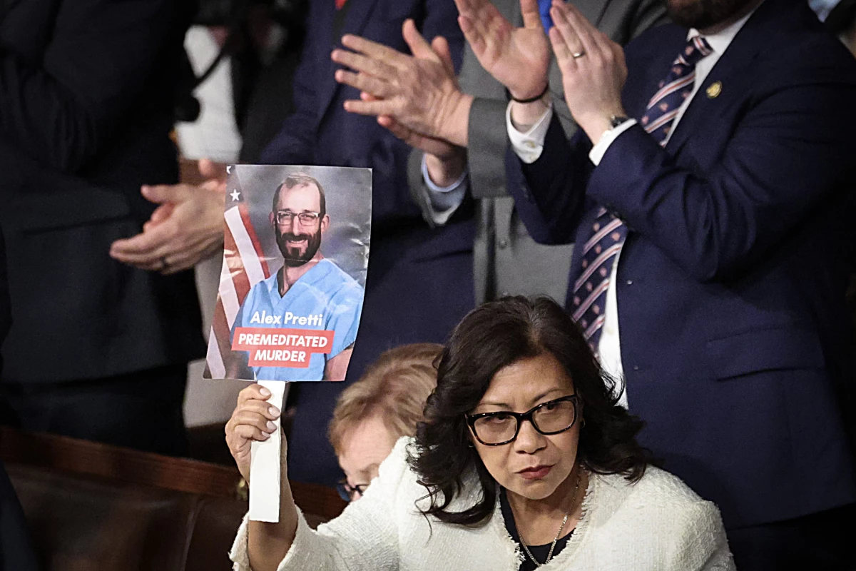 Rep. Norma Torres, D-Calif., holds up a photo of Minnesota shooting victim Alex Pretti during U.S. President Donald Trump's State of the Union at the U.S. Capitol on February 24, 2026, in Washington, DC.