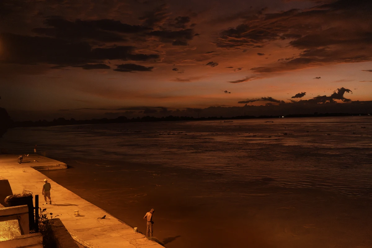 Dawn illuminates the dock and the Magdalena River in El Banco Magdalena, Colombia, on Aug. 9, 2022. The culture of the area, including cumbia, is deeply tied to the river and the fishermen.