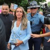 Karen Read walks outside a courthouse in a light blue suit.