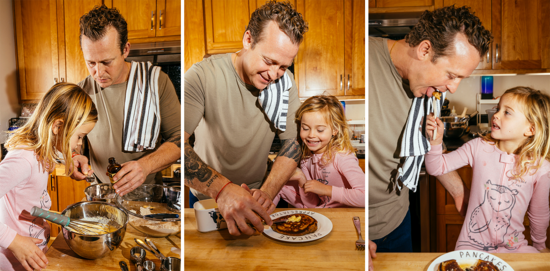 A triptych of photos that shows David Nayfeld making pancakes with his daughter in their kitchen at a wooden island. The first photo shows them putting vanilla extract into a metal mixing bowl. The second photo shows David cutting pancakes on a plate. And the third photo shows his daughter feeding him a bite of pancake.