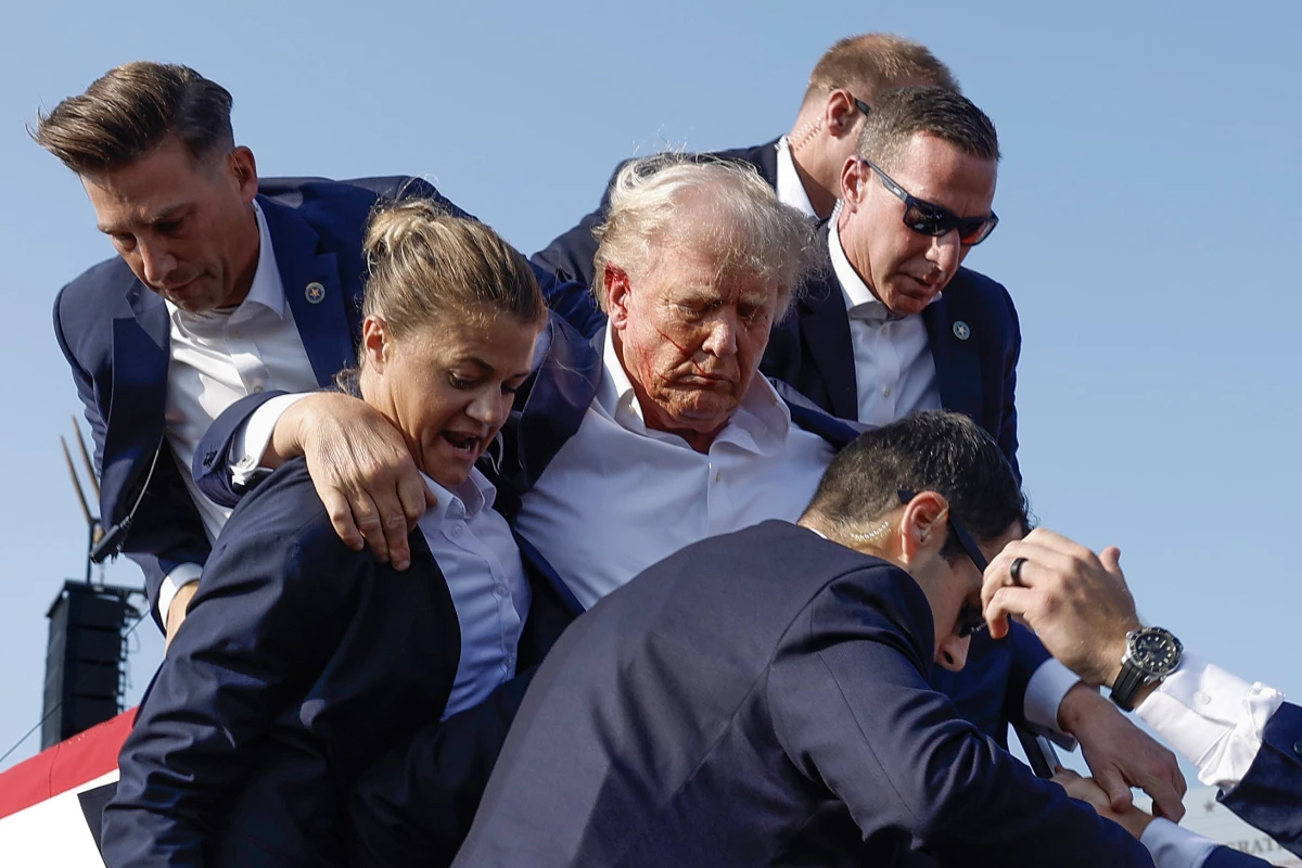 Former President Donald Trump is rushed offstage by U.S. Secret Service agents after being grazed by a bullet during a rally on July 13, 2024 in Butler, Penn.