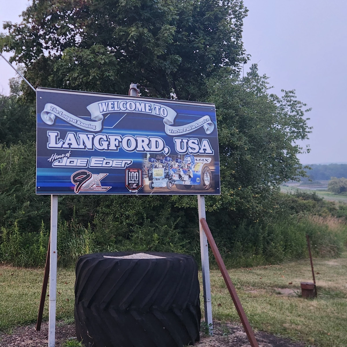 A welcome sign to the hamlet of Langford features Joe Eder, a tractor pull national champion and local legend.