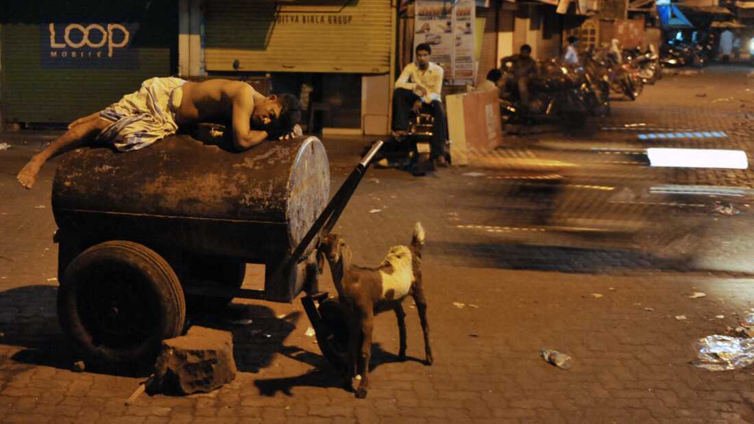 Hot overnight temperatures wreck people's sleep all over the world. In India, many people like this worker sleep outside to seek respite from searing temperatures. Climate change is making nights hotter, causing more sleep loss, according to a new study.
