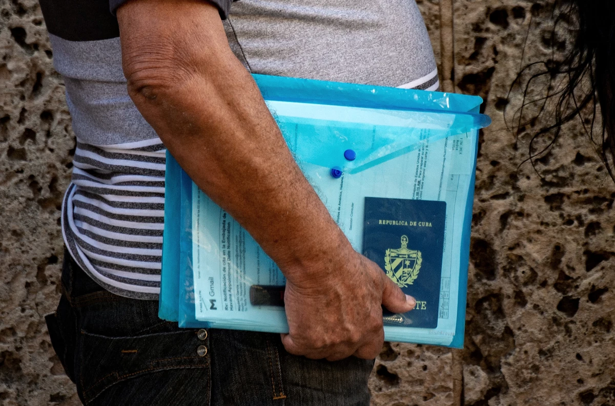 A Cuban with his documents queues at the U.S. embassy in Havana on May 3, 2022. Long times to get a visa plague the U.S. immigration system.