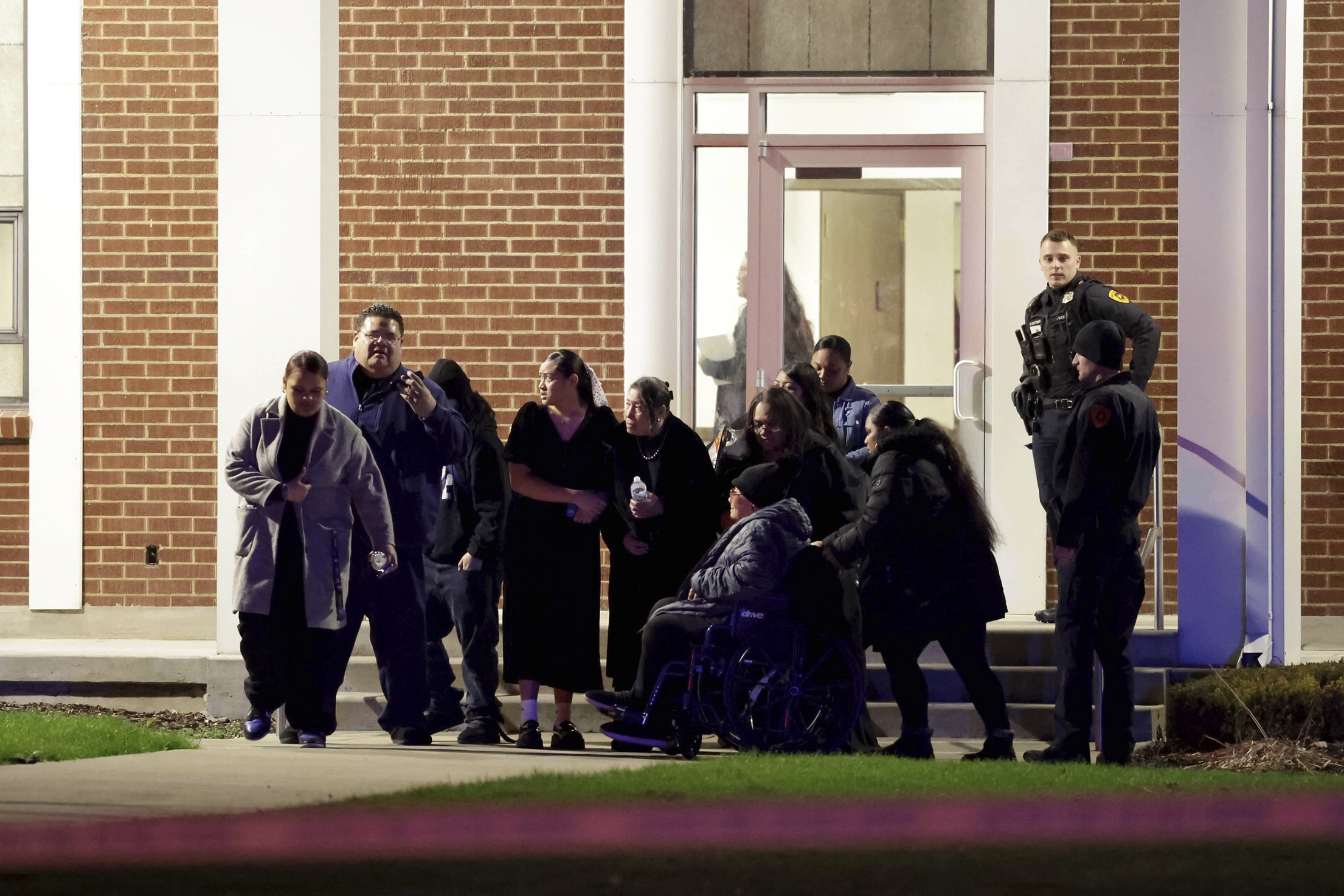 People attending a funeral at the The Church of Jesus Christ of Latter-day Saints in Salt Lake City leave after a fatal shooting in the parking lot  Wednesday, Jan. 7, 2025.