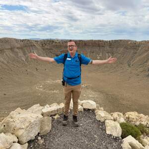 Hikers can walk to the bottom of Meteor Crater in Northern Arizona. Guide Tyler Johnson speaks to a group at the top of the mile-wide hole that was formed 50,000 years ago when a meteorite struck the earth.
