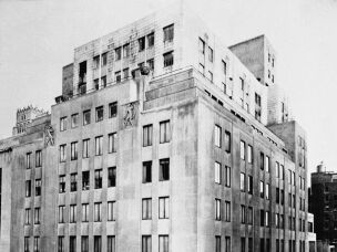 The Bonwit Teller Department store in New York City, with its art-deco sculptures framing the top row of windows before the balcony.