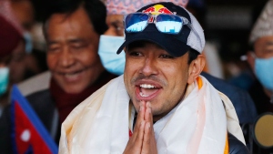 Nirmal Purja, one of the team member of the all-Nepalese mountaineering team that became the first to scale Mount K2 in winter, gestures as the team arrives at Tribhuwan International airport in Kathmandu, Nepal, Jan. 26, 2021.