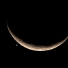 The crescent moon and Venus are pictured in Bangkok in 2023. A failed Soviet lander bound for Venus in 1972 and stranded in orbit is finally set to return to Earth.